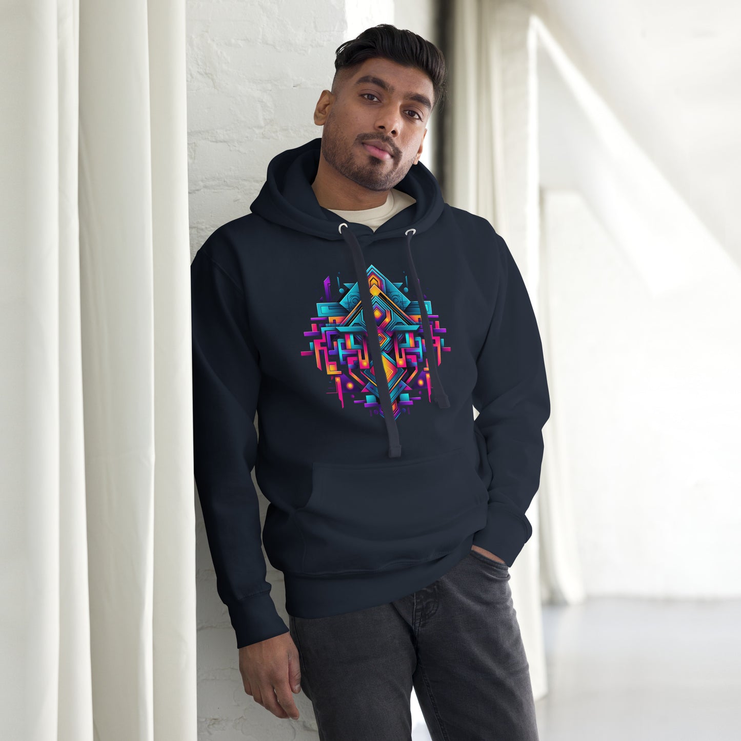 Een navy blazer unisex premium hoodie met een geometrische afbeelding, gedragen door een man, vooraanzicht, met een gordijn als achtergrond