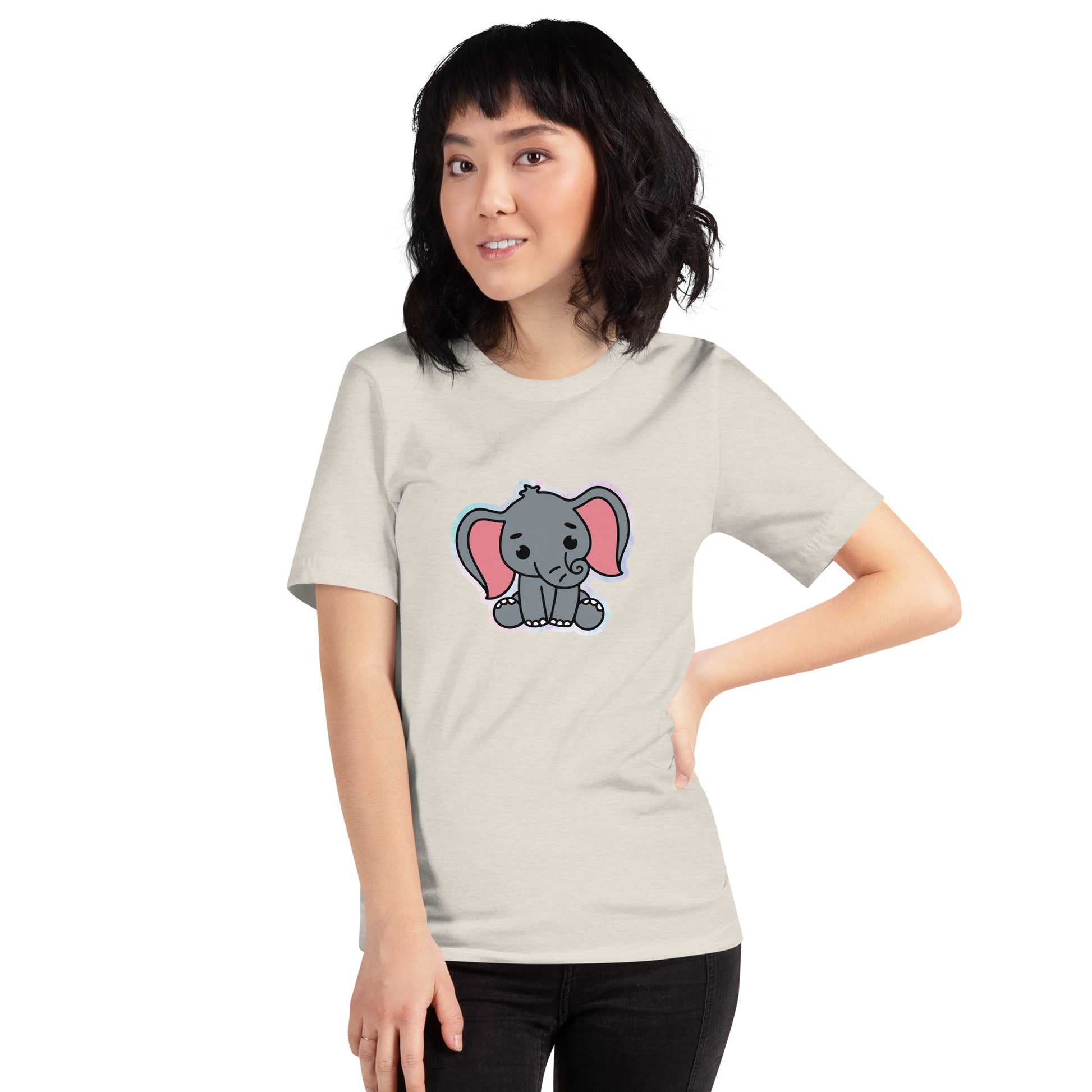 Een heather dust unisex T-shirt met een afbeelding van een grappige grijze baby olifant, gedragen door een vrouw, aan de voorzijde op een witte achtergrond.